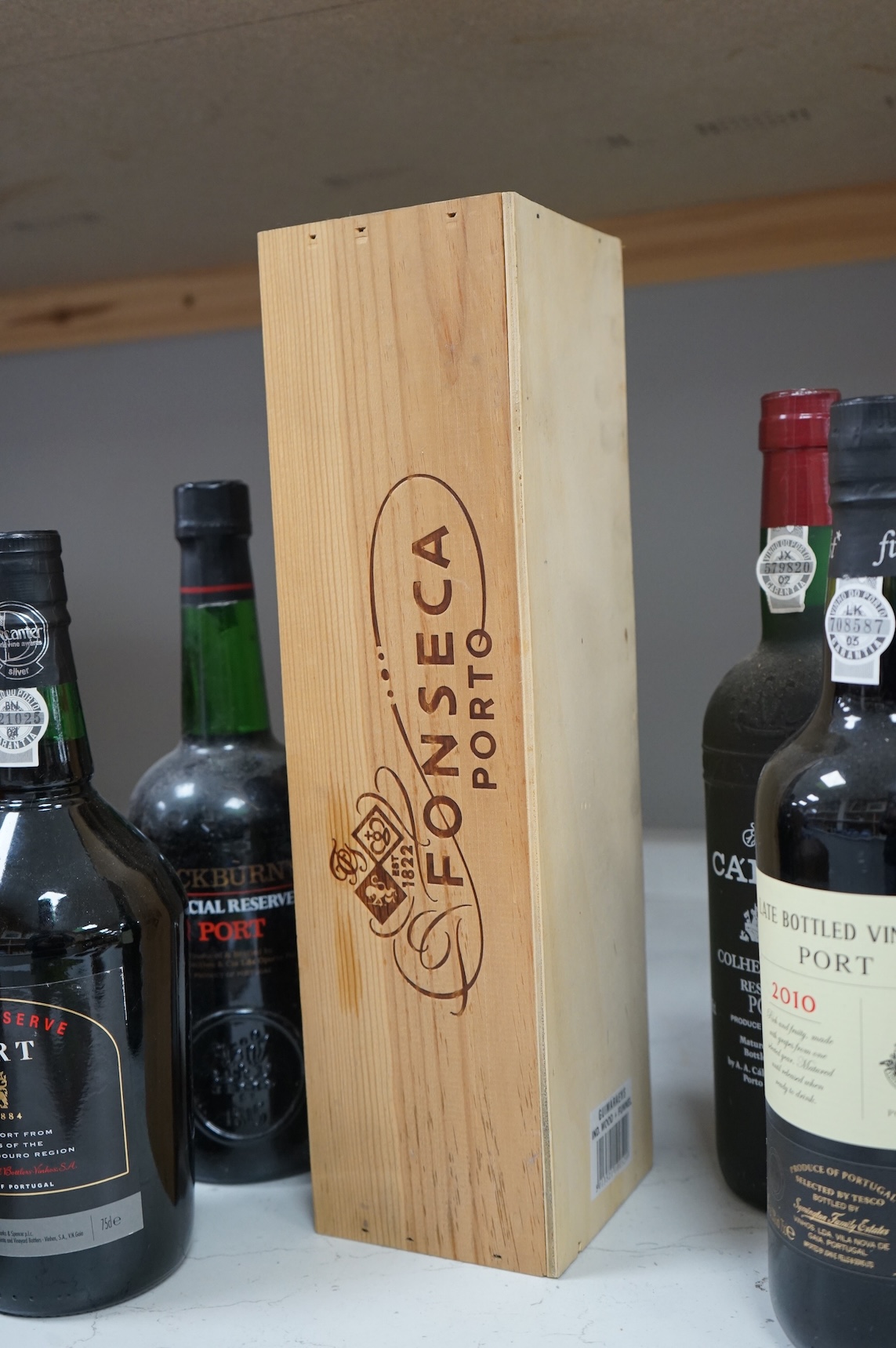 Five assorted bottles of port, including a boxed Fonseca 1988, a bottle of Calem 1987 and three other bottles of port.